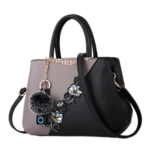  Fashionable women's handbag with floral pattern and splicing color design.