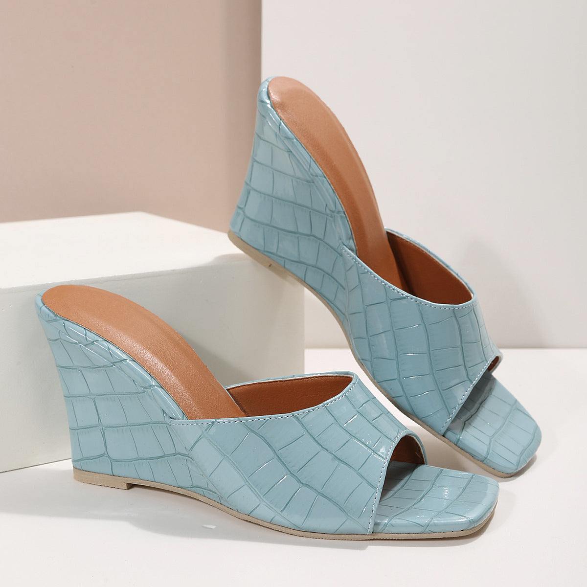 Close-up view of textured plaid design on wedge heel of JZ Women's sandals